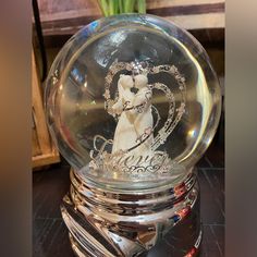 a crystal snow globe with a bride and groom on it