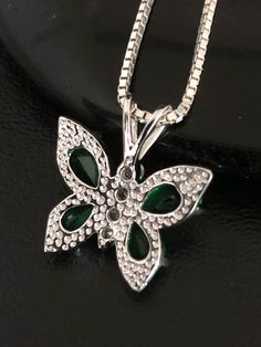 "Minimalist & Dainty Sterling Silver CZ Emerald Butterfly Necklace NECKLACE FEATURES: Metal: All components are made from solid .925 Sterling Silver Model is wearing 16\" in length solid .925 Sterling Silver Chain Length available: 16\", 18\" or 20\" Stone: CZ Emerald Butterfly Pendant Measurements: Height 18MM (0.7 Inches), including bail Width 16MM (0.6 Inches) Your Emerald Butterfly Necklace will arrive in a gift box, beautifully wrapped and ready for gifting Please send me a convo if you Green Sparkling Stones Necklace For Gift, Green Necklaces With Rhinestones As Gift, Green Rhinestone Necklace For Gift, Emerald Butterfly, Beaded Ankle Bracelets, Necklace Butterfly, Heart Anklet, Beaded Ankle, Ankle Chain