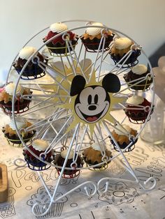 a ferris wheel with mickey mouse cupcakes on it