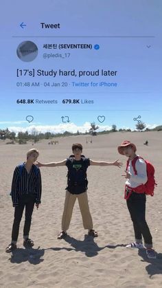 three young men standing on top of a sandy beach next to each other with their arms outstretched