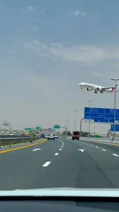 an airplane is flying low over the highway