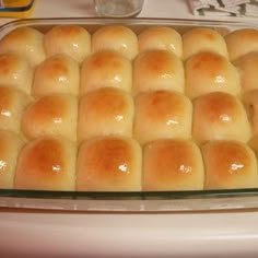 a baking pan filled with rolls on top of a counter