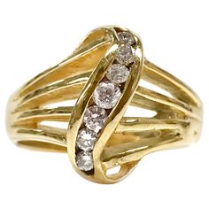 14 Karat Seven-Diamond Ring. The multi-split band ring features seven round channel-set diamonds vertically-set at the center in a gold curve. The diamonds range in size from 2.0mm to 2.5mm. The seven diamonds have a total carat weight of 0.20ctw. Stamped on the inside of the band is DZ 14K. The ring size is 6 1/4 and has a gold weight of 5.6 grams. Gems Ring, Diamond Gold, Vintage Band, Channel Set, Estate Jewelry, Band Ring, Rose Gold Ring, Band Rings, Gold Diamond