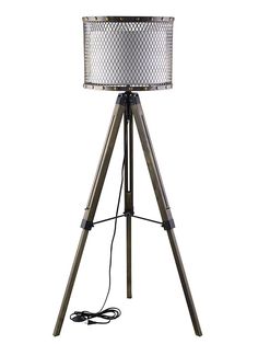 a tripod floor lamp with a silver shade