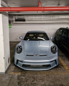 two cars parked in a parking garage next to each other