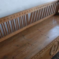 an old wooden bench sitting in the corner of a room next to a wall and floor