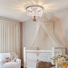 a baby's room with a crib, rocking chair and teddy bear in it