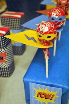 some lollipops sitting on top of a blue table