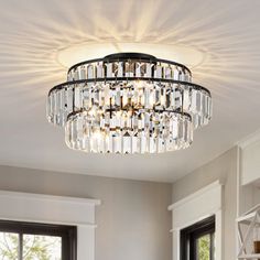 a chandelier hanging from the ceiling in a living room