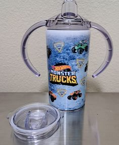 there is a cup that has some trucks on it