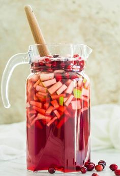 a jar filled with cranberry and apple cider punch