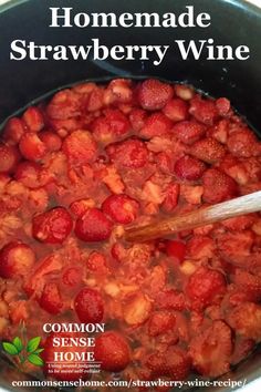 a pot filled with strawberries sitting on top of a stove