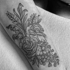 a black and white photo of flowers on the leg