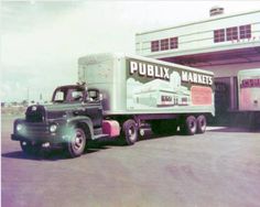 an old truck is parked in front of a building with a sign that says publix markets