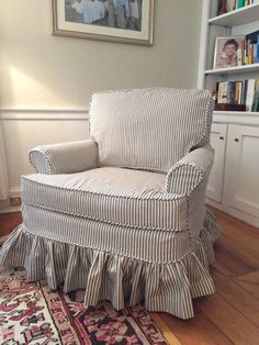 a chair with a ruffled skirt sitting on top of a wooden floor next to a rug