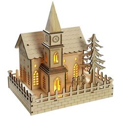 a wooden model of a church with trees and lights