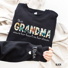 someone is holding onto a black shirt with the words grandma on it