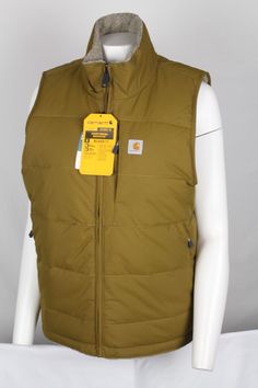 Condition:  New With Tags Sizes Available: **See Drop Down Menu Color:  Oak Brown Stay warm and stylish with this Carhartt Women's Montana Puffer Vest. The vest is made of a 4.5-ounce, 100% silicone-coated nylon outer shell material with a solid pattern in a relaxed fit. It features a sleeveless design with a zip and snap closure and is suitable for travel, casual wear, and workwear. The brown color and fleece fabric type make it a perfect choice for all seasons. The vest is insulated with polyester and has pockets for convenience. It is a reversible basic jacket style with a full zip and is suitable for women. The Carhartt brand guarantees quality and durability. Get your hands on this stylish vest today! Carhart Vest Women, Carhartt Vest Womens, Carhartt Women Vest, Carhartt Women’s Vest, Brown Hunting Vest With Pockets, Carhartt Womens, Basic Jackets, Puffer Vest, Solid Pattern