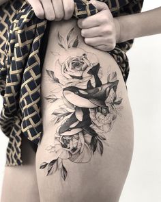 a woman's thigh with flowers on it