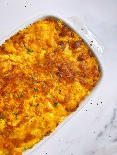 a casserole dish with cheese and parsley on the top is ready to be eaten