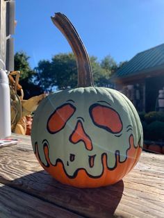 a pumpkin with a face painted on it