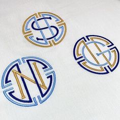 three circular monogrammed iron - on patches with initials