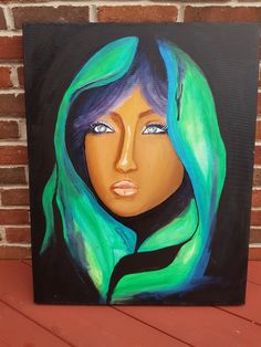 a painting of a woman's face with blue hair and green scarf on a brick wall