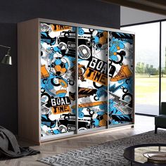 a room with a couch, chair and large sliding glass door that has an image of various sports related items on it