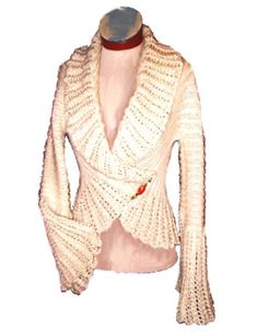 a white knitted jacket on a mannequin's dummy with red buttons