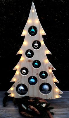 a wooden christmas tree with lights on it