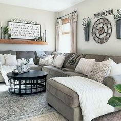 a living room filled with lots of furniture and decor on top of a white rug