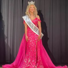 a woman in a pink gown with a crown on her head