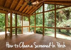 the inside of a screened - in porch with wood flooring and ceiling fan on it