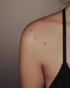 a woman's back shoulder with small stars on it