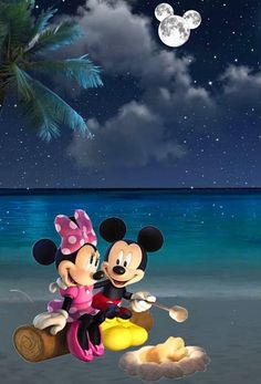 mickey and minnie mouse on the beach at night