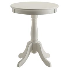 a small white table with an oval top and two pedestals on one side,