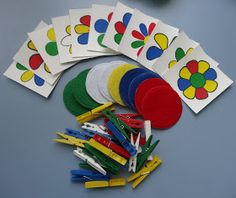 many different colored paper clips and magnets on a table