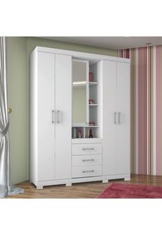 a white wardrobe with drawers and shelves next to a pink rug on the wooden floor