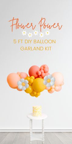 balloons are floating in the air over a table with a cake and flowers on it