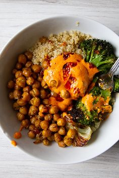 a white bowl filled with broccoli and chickpeas