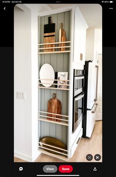 an open bookcase in the corner of a room with plates and other items on it