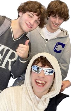 three young men in hooded sweatshirts and sunglasses giving the thumbs up sign with their hands