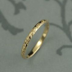 a gold wedding ring on a gray background