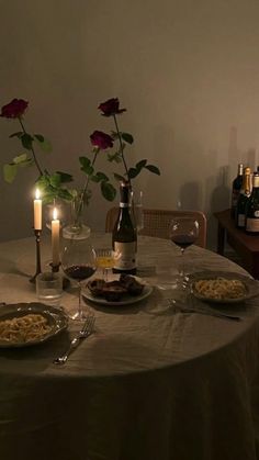 the table is set for two with wine and food