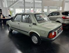 an old car is parked in a showroom