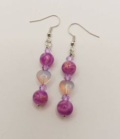 One of a Kind Handmade Purple Beaded Earrings These super cute Purple Beaded Earrings are a perfect gift for that special person in your life, especially if that person is you! <3 Each item is handcrafted with healing crystals and genuine gemstones, pieces from repurposed and vintage jewelry, as well as recycled materials. ️☪️ Cute Purple Dangle Jewelry, Dangle Crystal Earrings With Czech Glass For Gift, Gift Heart Beads Drop Earrings, Czech Glass Dangle Crystal Earrings For Gift, Czech Glass Crystal Dangle Earrings As Gift, Colorful Beaded Adjustable Earrings As Gift, Whimsical Adjustable Beaded Earrings, Adjustable Colorful Beaded Earrings As Gift, Adjustable Colorful Beaded Earrings For Gifts