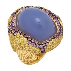 Blue Chalcedony 32.10 Carat Yellow Purple Sapphires 18 Karat Yellow Gold Ring Absolutely spectacular Blue Chalcedony Cabochon-shape weighing 32.10 Carat in our Ring from "New Age" Collection. It surrounded by 18 Karat Yellow Gold and a mix of 96 Purple Sapphires weighing 3.02 Carat and 208 Yellow Sapphires weighing 7.71 Carat inspires thoughts about something mystic. Therefore, you can wear our ring for completely different events. In set with Earrings LU1164115092002. Please request a video link to check this beauty in action US Size 7 3/4// 55 7/8 EU Size 30 x 32.40 mm (WxH) Weight - 26.08 gm. Purple Sapphire Ring, Purple Stone Rings, Purple Ring, Diamond Bracelet Design, Vintage Cocktail Ring, Purple Rings, Purple Diamond, Purple Sapphire, Purple Stones