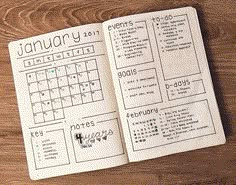 an open planner sitting on top of a wooden table