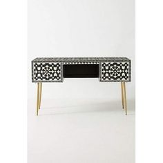 a black and white desk with two drawers on one side and an ornate design on the other