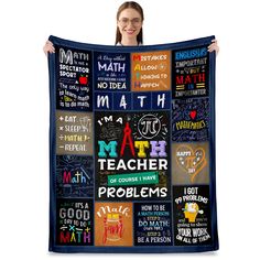 a woman holding up a blanket with many different words on it